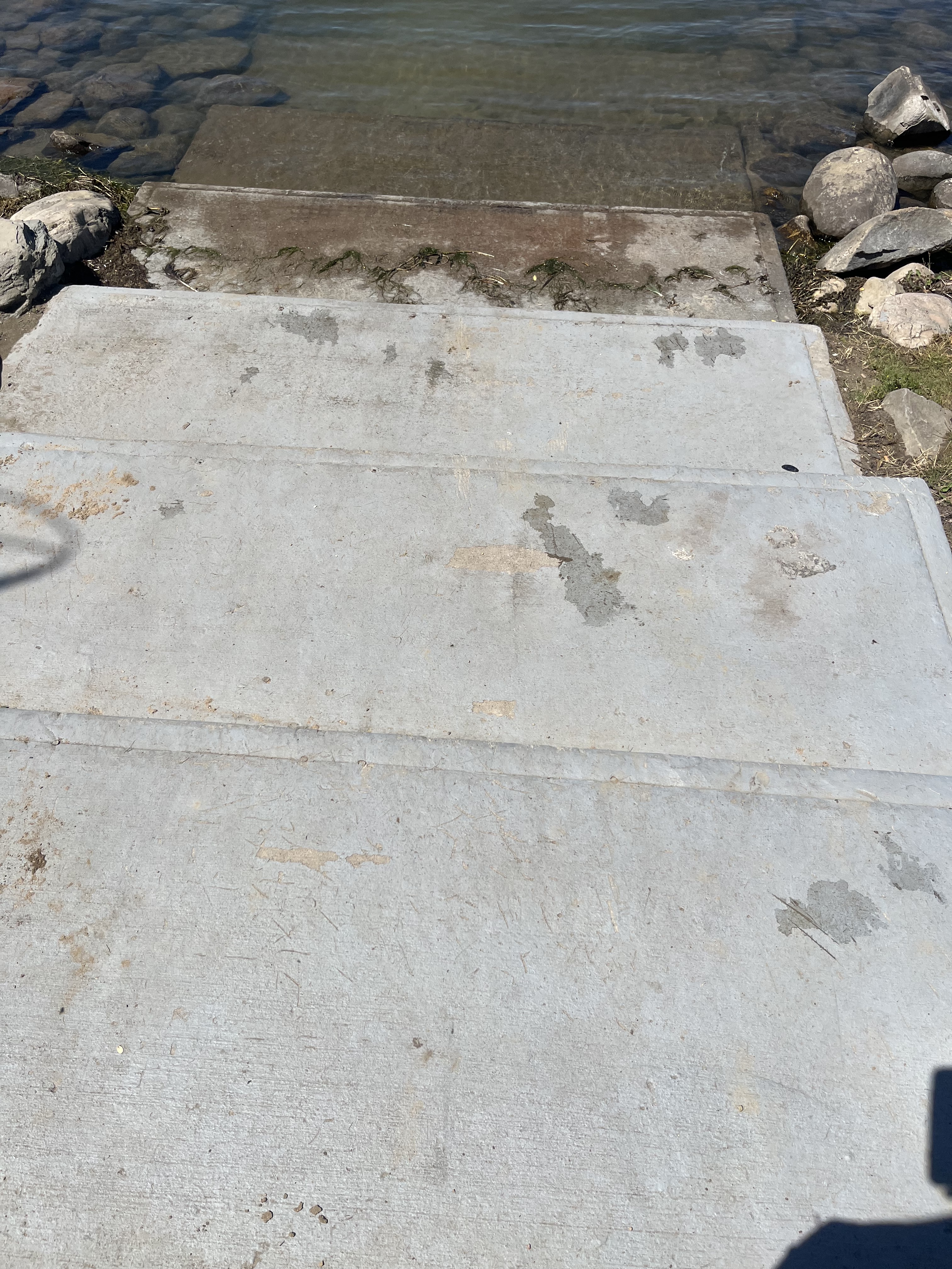 Cement stairs leading into the water. Three steps total.